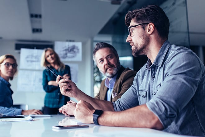 A team of employees discussing projects in a conference room