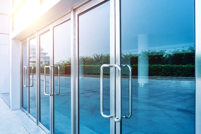 Shiny for to ceiling glass doors on the front of a commercial building