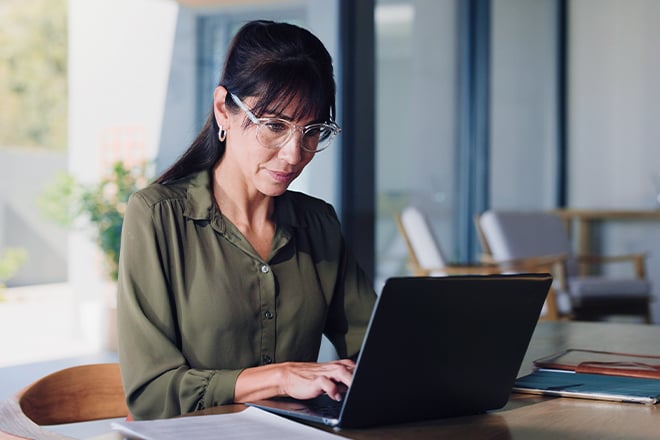 Businesswoman doing research on a laptop.