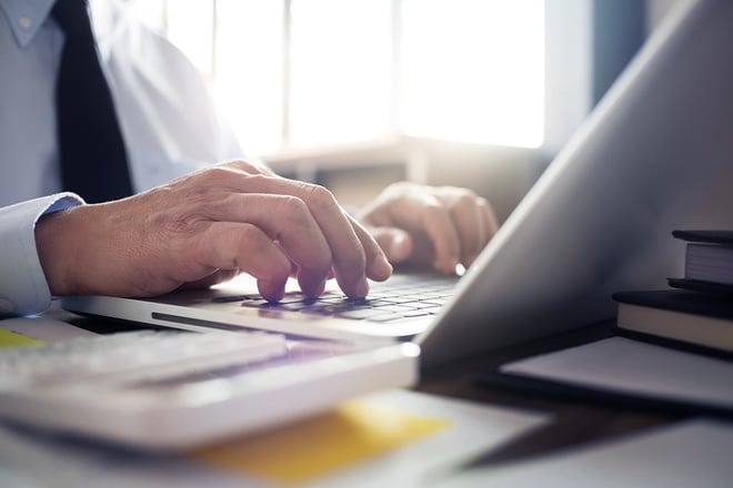Business analyst using on laptop in a modern office.