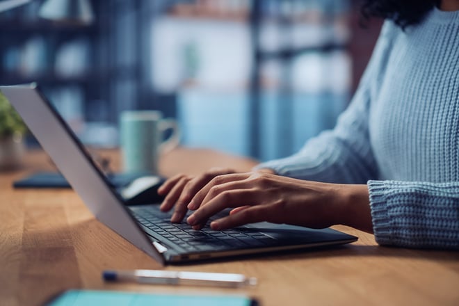 Close Up on Hands of a Female Working on Laptop Computer