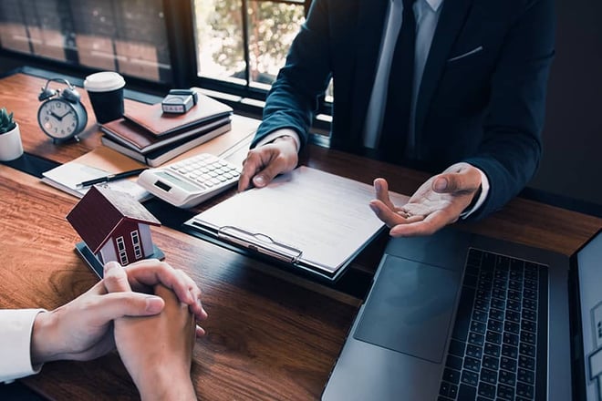 A property manager looking at paperwork with a client.