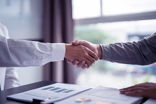 Close up of two business people shaking hands.