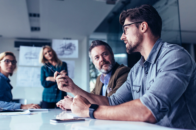 A team of employees discussing projects in a conference room