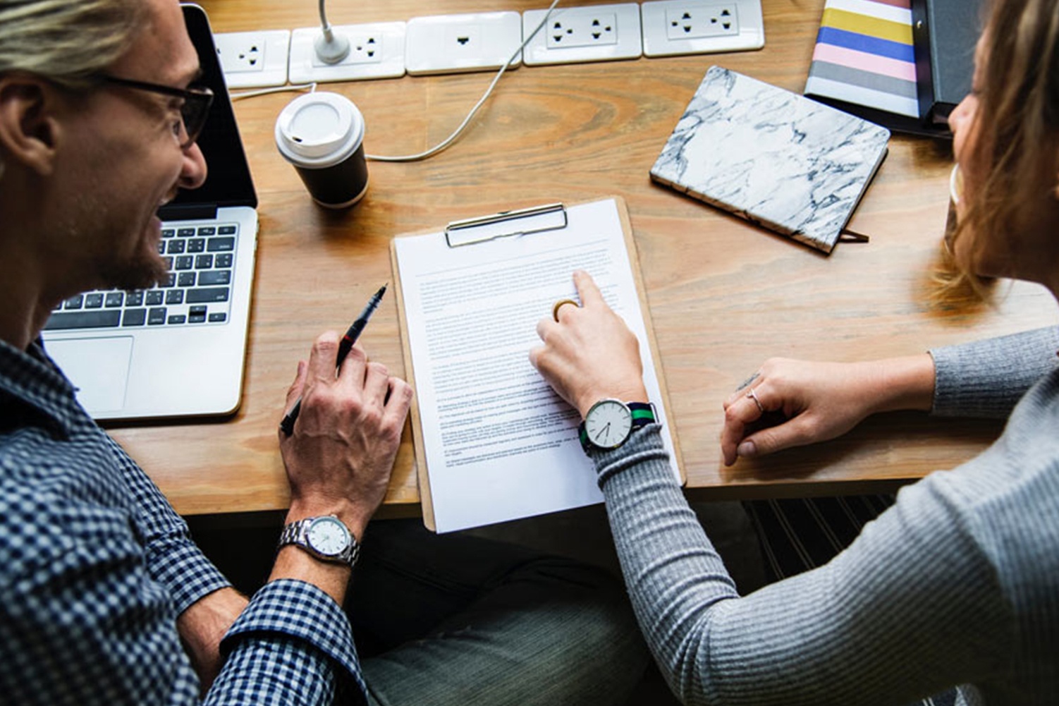 two people going over paperwork together