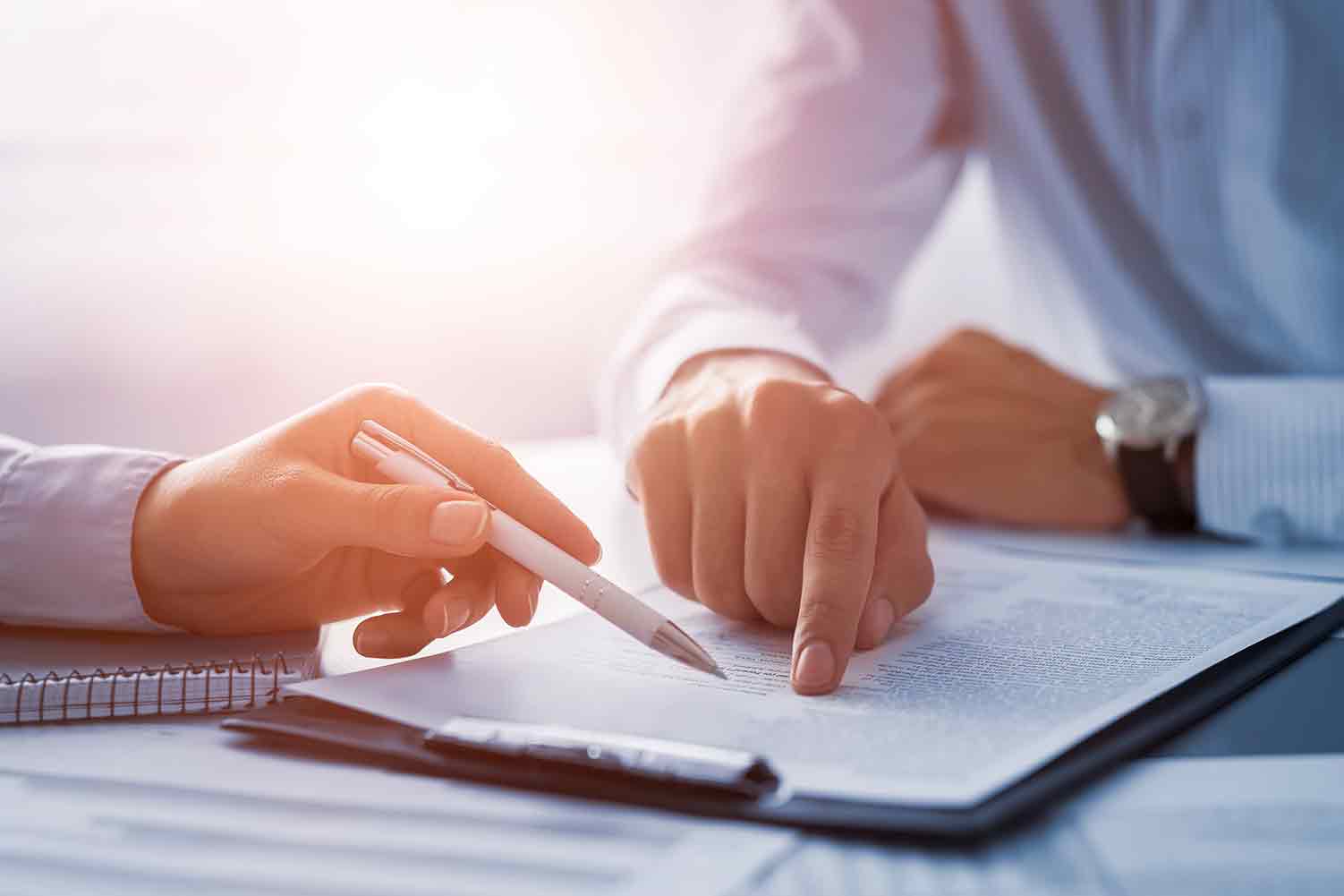 two people going over paperwork on clipboard