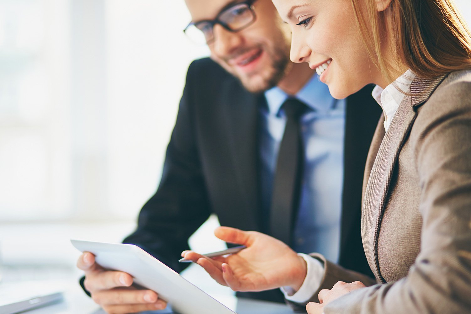 two people looking at tablet