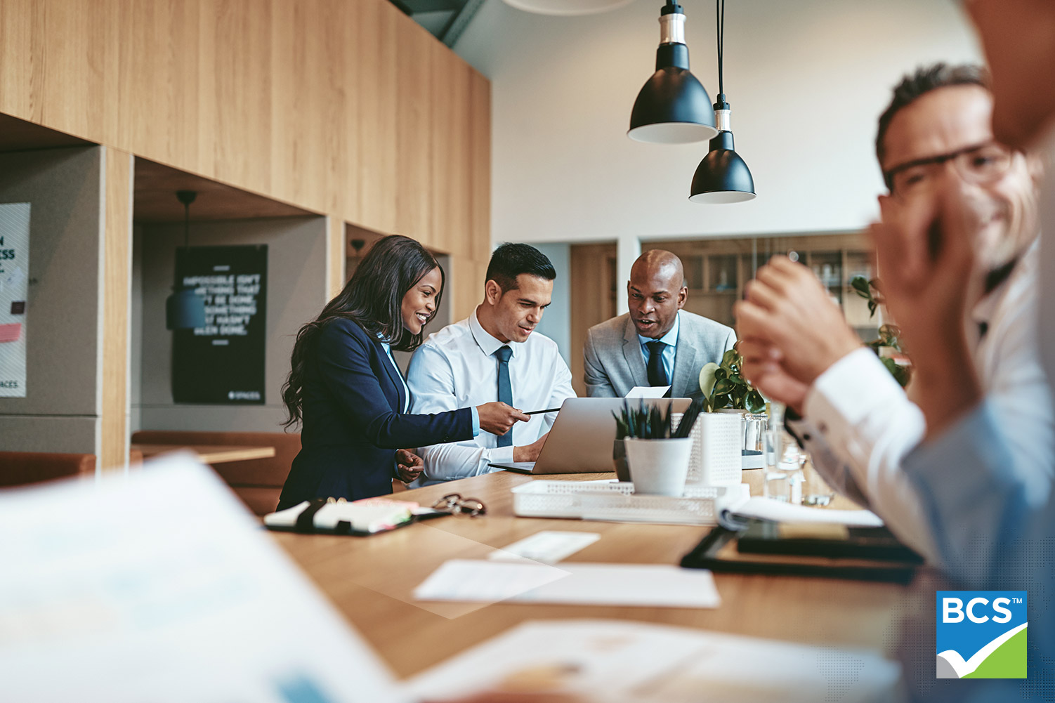 Image of a business person using laptop during meeting