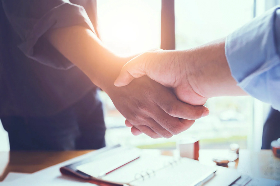 men shaking hands in an office setting