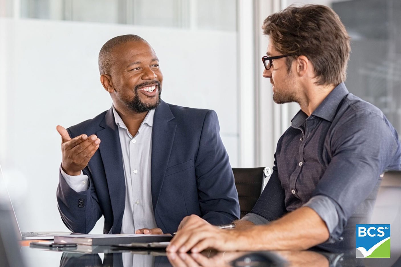 two businessmen talking with each other