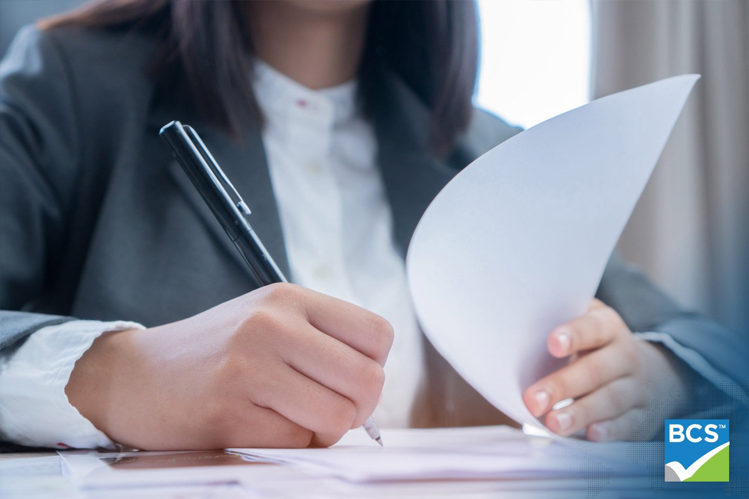 woman signing a claim form