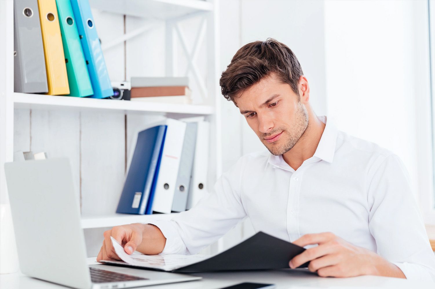 man in office looking at documents