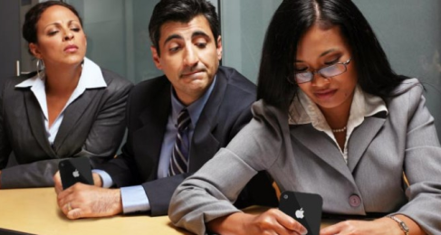 man looking over woman's shoulder at her phone