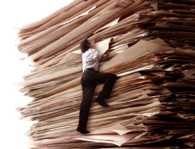 man climbing stack of paperwork