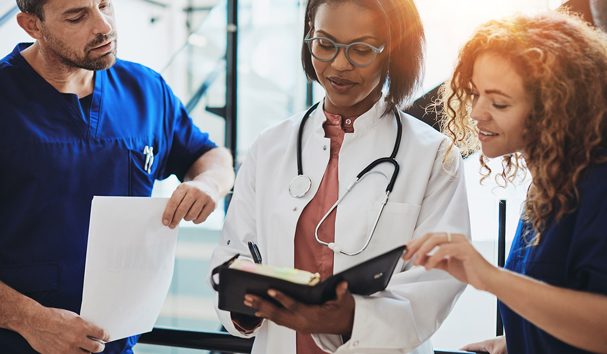 doctors-working-together-and-looking-at-notepad doctors-working-together-and-looking-at-notepad