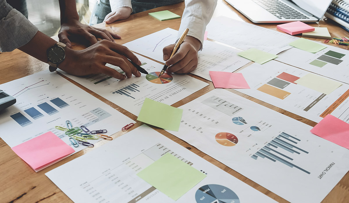 employees-looking-down-at-financial-documents employees-looking-down-at-financial-documents